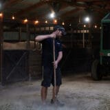 On Sept. 26, 2023, in Sedalia, Missouri, Joe Carr, 32, sweeps the dried hay for feeding his four rescue horses. This smaller barn is home to four rescue horses.