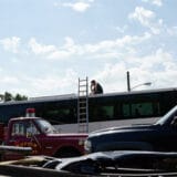Joe Carr, 32, takes a business call while repairing the air conditioning on the roof of a large commercial passenger bus in Sedalia, Missouri. Joe Carr will take on a new position at John Deere a week from today, Sept. 27, 2023, leading him to close his automotive repair shop, “Full Throttle.”